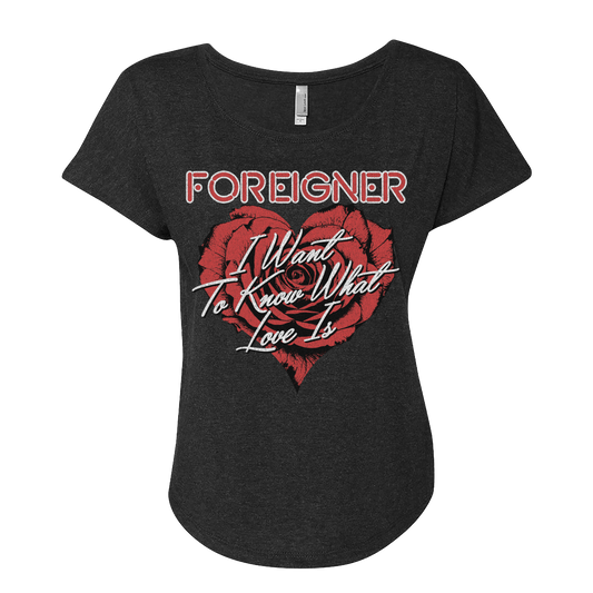 A black ladies scoopneck t-shirt with a heart and text design, featuring the phrase 'FOREIGNER I Want To Know What Love Is'.