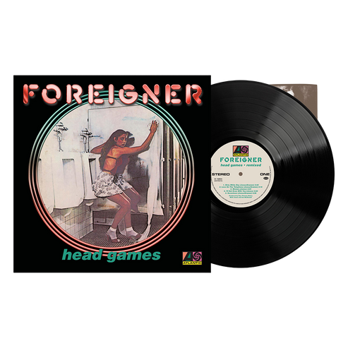 Vinyl record album 'head games' by Foreigner, showing the black LP partially pulled from the black sleeve, which features a vintage-style illustration of a woman in a bathroom.