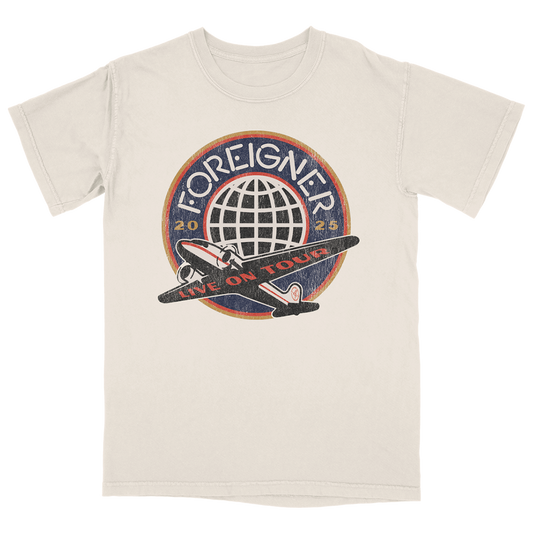 A white t-shirt with a round logo graphic on the front, featuring text and a graphic of a plane with 'FOREIGNER 2025' around it.